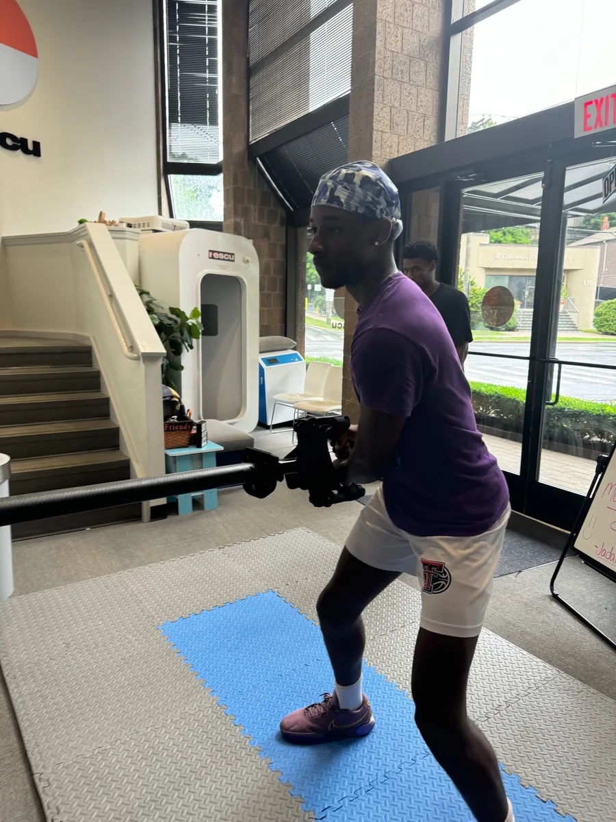 Person performing a resistance exercise by the window at Rescu
